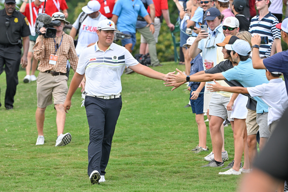 Im Sung-jae high-fives fans while walking to the sixth tee box during the final round of the Tour Championship at East Lake Golf Club on Sunday in Atlanta, Georgia. [GETTY IMAGES]
