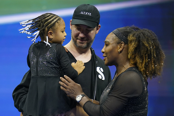 Serena Williams, right, talks with her daughter Olympia and husband Alexis Ohanian after defeating Danka Kovinic of Montenegro during the first round of the US Open women's singles on Monday in New York. [AP/YONHAP]