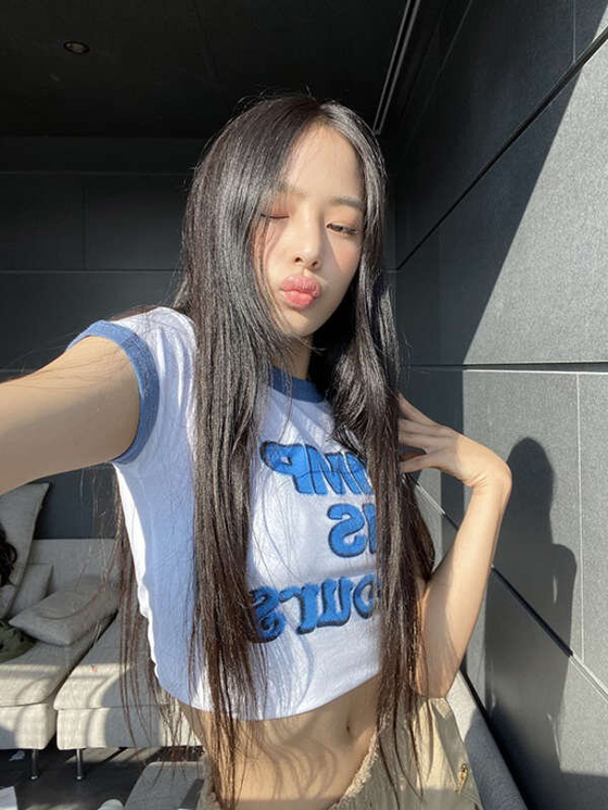 A crop top worn by an underage member Minji of NewJeans also came under fire for featuring the phrase “pimp is yours.” [SCREEN CAPTURE]