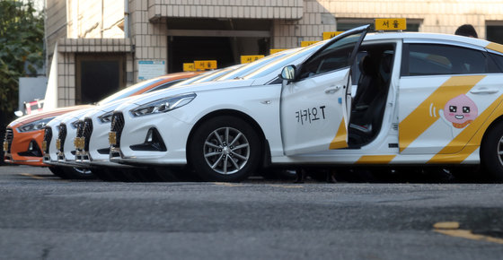 Kakao taxis are parked in a parking lot in Seoul. [YONHAP]