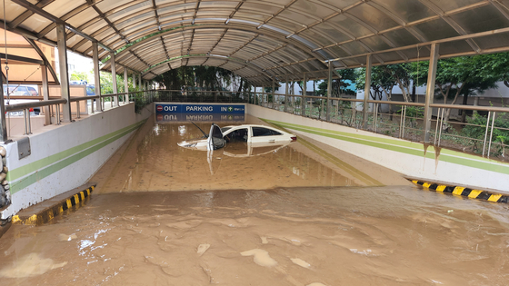 A car is submerged at a parking lot in Pohang, North Gyeongsang on Tuesday. [GYEONGBUK FIRE SERVICE HEADQUATERS] 