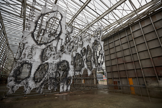 ″Landscape with Many Holes: Skins of Yeongdo Sea″ (2022) by Mire Lee, which is made from scaffolding, waste oil and fencing materials. It is being exhibited at the Yeongdo venue. [BUSAN BIENNALE]