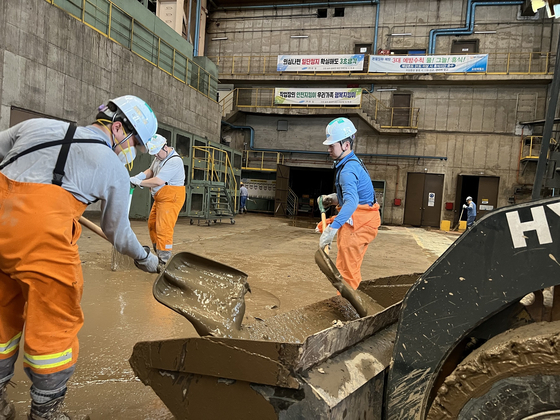 Posco employees help with recovery at its Pohang steel plant in North Gyeongsang on Wednesday. [POSCO] 