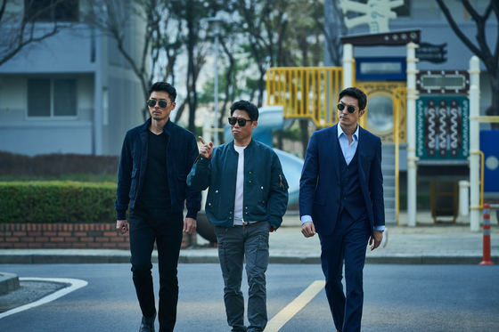 Jack reluctantly cooperates with North Korean and South Korean detectives Cheol-ryung and Jin-tae, portrayed by Hyun Bin and Yoo Hai-jin left and center, to complete his mission. [CJ ENM]                