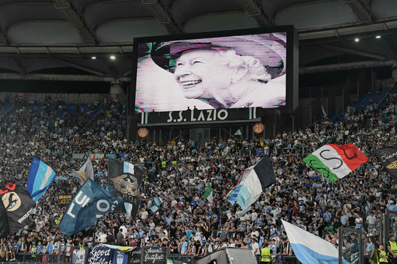 A portrait of Britain's Queen Elizabeth II is displayed on a giant screen following the announcement of her death, prior to the start of the UEFA Europa League Group F first leg football match between SS Lazio and Feyenoord Rotterdam at the Olympic stadium in Rome on Thursday. [AFP/YONHAP]