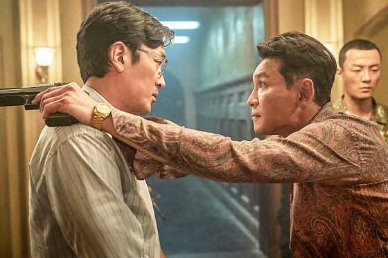 A scene in Netflix's “Narco-Saints,” featuring actors Ha Jung-woo, left, and Hwang Jung-min, right. [NETFLIX]
