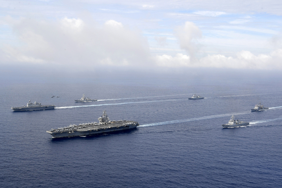In this photo provided by Korea's Defense Ministry, the U.S. nuclear-powered aircraft carrier USS Ronald Reagan, second from left, and South Korea's landing platform helicopter ship Marado, left, sail during a joint military exercise at an undisclosed location on June 4. [AP/YONHAP]