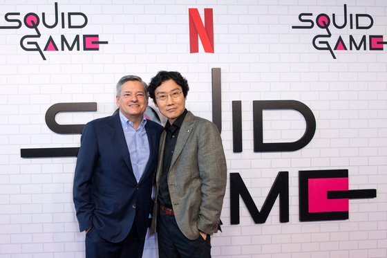 Hwang, on the right, poses for a photo with Netflix CEO Ted Sarandos at Raleigh Studios in Los Angeles on June 12. [AFP/YONHAP]