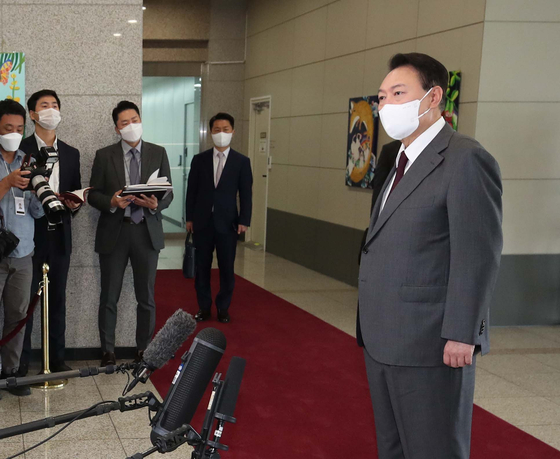 President Yoon Suk-yeol answers a question about alleged mismanagement of solar power and other renewable energy sources projects by the previous administration at the Yongsan presidential office in central Seoul Thursday. [JOINT PRESS CORPS]
