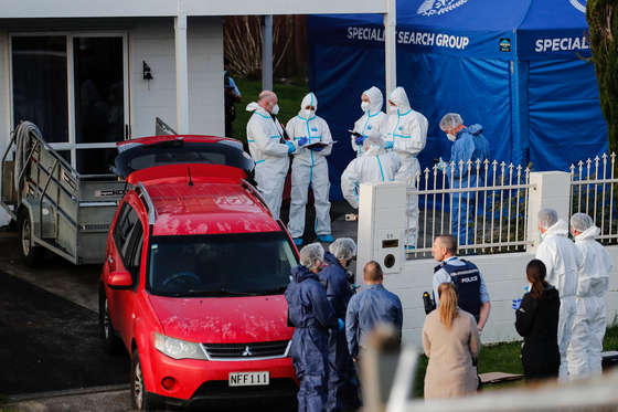New Zealand police in Auckland on Aug. 11, 2022, after the bodies of two children were discovered in suitcases. [AP]