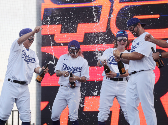 From left: Jeong Keun-woo, Kwak Yoon-gy and Ashton Lansdell of the Los Angeles Dodgers cover teammate Adrian Gonzalez with champagne after he was named MVP at the 2022 FTX MLB Home Run Derby X at Paradise City in Incheon on Saturday.  [YONHAP]