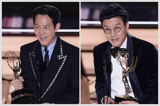 Actor Lee Jung-jae, right, and director Hwang Dong-hyuk speaks during their respective acceptance speech for their Emmy Awards at the 74th Primetime Emmy Awards on Monday at the Microsoft Theater in Los Angeles. [AP/YONHAP]