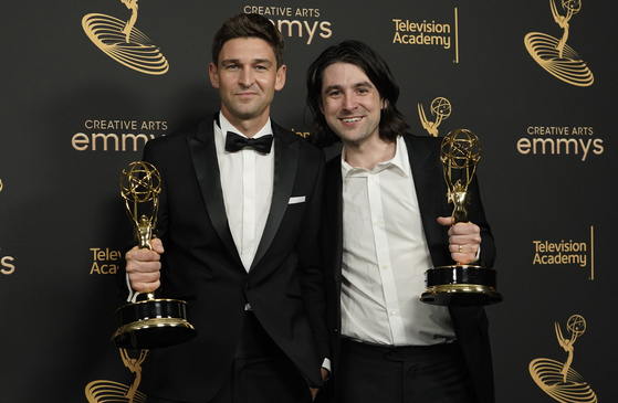 Oliver Latta, left, and Teddy Banks pose in the press room with the award for outstanding main title design for ″Severance″ on night two of the Creative Arts Emmy Awards on Sept. 4, 2022, at the Microsoft Theater in Los Angeles. [AP/YONHAP]