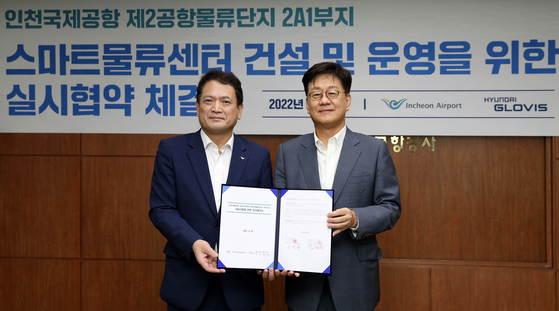 Hyundai Glovis CEO Kim Jung-hoon, right, poses for a photo with Incheon International Airport Corporation CEO Kim Kyung-wook after signing a memorandum of understanding Thursday. [HYUNDAI GLOVIS] 