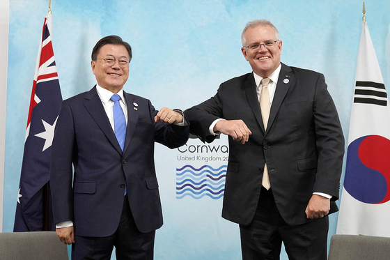 President Moon Jae-in, left, with Australia's Prime Minister Scott Morrison, meet on the sideline of the G7 summit in Cornwall, England, in June. [BLUE HOUSE]