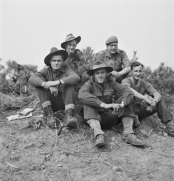 Members of 4 Platoon, B Company, 3RAR rest near Kapyong the day after the battle in the Korean War, on April 26, 1951. [AUSTRALIAN WAR MEMORIAL]