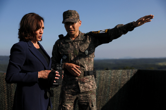 U.S. Vice President Kamala Harris, left, holds binoculars at a military observation post as she visits the demilitarized zone (DMZ) in the truce village of Panmunjom at the inter-Korean border Thursday afternoon. [REUTERS/YONHAP]