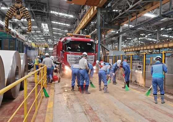 Posco employees clean up at the Pohang steel mill in North Gyeongsang, which was flooded by Typhoon Hinnamnor earlier in the month. The steelmaker said it needs at least three months for production to normalize. [POSCO]