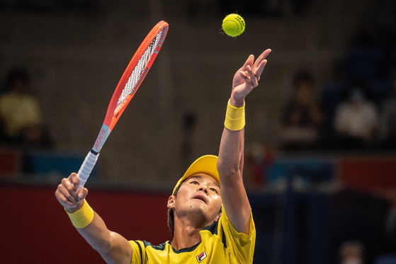 Kwon Soon-woo serves a ball to Mackenzie McDonald of the United States during their men's singles round of 16 match at the Japan Open in Tokyo on Wednesday. [AFP/YONHAP]