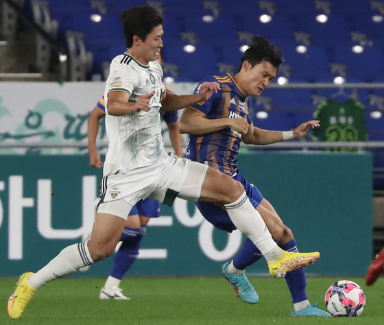 Cho Gue-sung of Jeonbuk Hyundai Motors dribbles the ball past Ulsan Hyundai's Oh In-pyo during an FA Cup semifinal match on Wednesday at Ulsan Munsu Football stadium in Ulsan. [NEWS1]