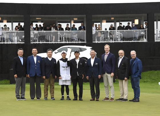 Kim Yeong-su, winner of the 2022 Genesis Championship, fifth from left, and Euisun Chung, chairman of Hyundai Motor Group, sixth from left, pose for a photo on Sunday. The golf tournament, hosted by Hyundai Motor, took place Thursday to Sunday. [HYUNDAI MOTOR]