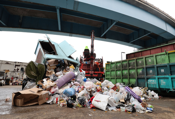 Garbage is piled up at a garbage dump under the Wonhyo Bridge that connects Yeouido and Yongsan on Sunday. [YONHAP]