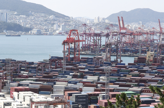 Containers are piled up at a port in Busan on Friday. [YONHAP]
