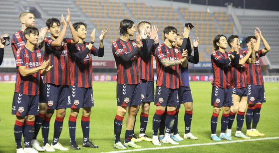 Suwon FC players celebrate beating Seongnam FC at Suwon stadium in Suwon, Gyeonggi on Wednesday to secure their place in the top tier next season. [NEWS1]