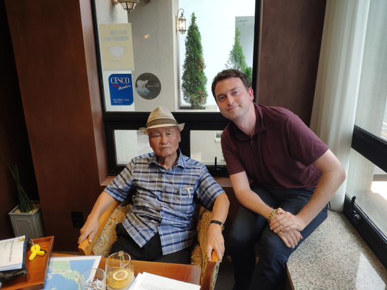 The author, right, with veteran and activist Ku Yon-chol at a cafe in Busan on Aug. 31. [NIKOLAI JOHNSEN]