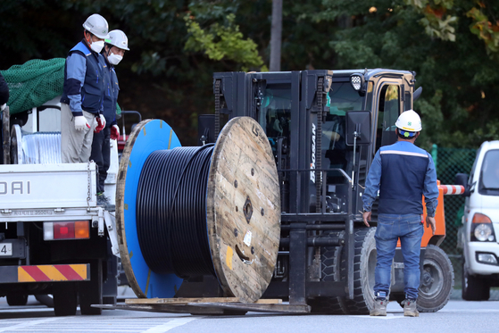 Wires and equipment are being moved near the SK C&C building in Pangyo, Gyeonggi, for the restoration procedure of the data center on Monday. [NEWS1]