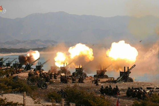 In this still from footage released by Pyongyang's state-controlled Korean Central Television (KCTV), North Korean artillery units conduct a firing exercise at an undisclosed location in March 2020. [YONHAP]