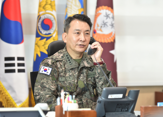 South Korea's Joint Chiefs of Staff Chairman Gen. Kim Seung-kyum talks over the phone with his U.S. counterpart, Gen. Mark Milley, in Seoul on Oct. 5, one day after North Korea's intermediate-range ballistic missile launch into the Pacific the previous day. [YONHAP]