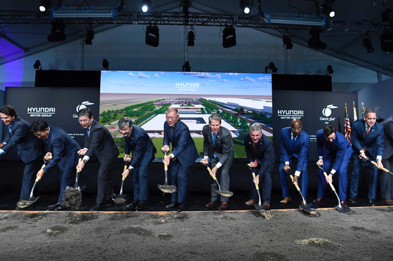 Representatives from Hyundai Motor Group and the Georgia state government, including Executive Chair Euisun Chung, fifth from left, and Georgia Gov. Brian Kemp, sixth from left, hold shovels during a groundbreaking ceremony for the company's EV factory in Georgia Tuesday. [HYUNDAI MOTOR] 