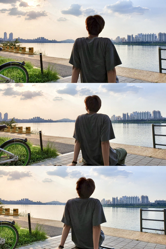 BTS's RM sits by the Han River during the boy band's two-month vacation in August 2019. [SCREEN CAPTURE]