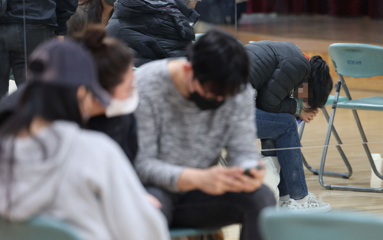 Families and friends of people missing after a crowd crush in Itaewon Saturday night wait for news in the basement floor of Hannam-dong Community Service Center in Yongsan District, central Seoul, on Sunday. [YONHAP]