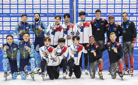 Teams from Canada, Korea and Kazakhstan hold up their medals following the men's 5000-metre relay race at the ISU World Cup Short Track Speed Skating event in Montreal on Sunday. [AP/YONHAP]