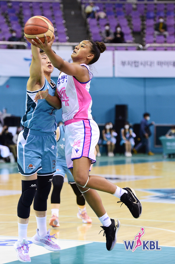 Kianna Smith of the Yongin Samsung Life Blueminx, right, plays the ball against Hana OneQ on Monday at the Bucheon Gymnasium in Bucheon, Gyeonggi. [WKBL]