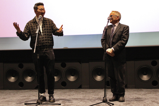Ahn, left, and Peter L. Stein, programmer for Frameline, the renowned San Francisco International LGBTQ Film Festival, greet the audience at the opening ceremony of Sipff at Megabox Seongsu branch in eastern Seoul on Nov. 3. [SIPFF]