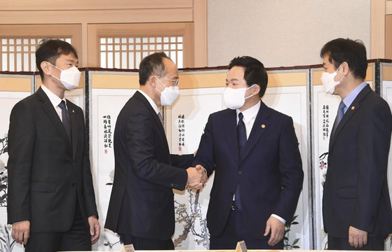 Finance Minister Choo Kyung-ho, second from left, shakes hands with Land Minister Won Hee-ryong, second from right, ahead of a ministers' meeting in Seoul on Nov. 10. [YONHAP]