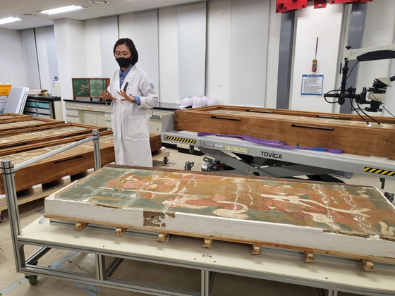 Jeong So-young, the director of the Cultural Heritage Conservation Science Center, explains the conservation process of the Mural Painting in Josadang Shrine of Buseok Temple, a national treasure that came to the center in 2020. [YIM SEUNG-HYE]