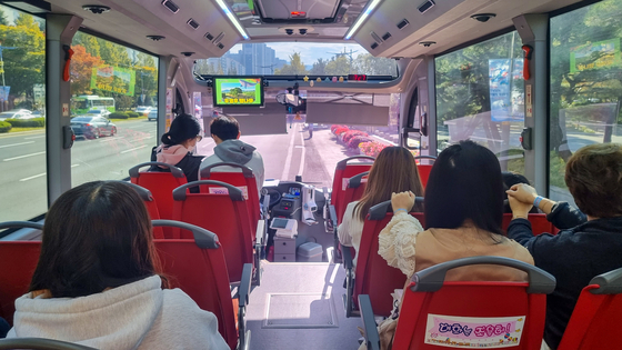 Tourists ride the Woo Young-woo Hackberry Tree City Tour Bus to see the hackberry tree in Bukburi Village.[CHANGWON CITY GOVERNMENT]
