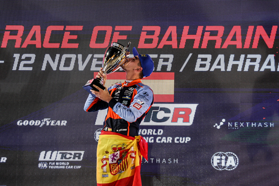 BRC Hyundai N Squadra Corse driver Mikel Azcona poses with the trophy after winning Race 1 at the World Touring Car Cup Race of Bahrain 2022 on Saturday. Azcona's win was immediately followed by teammate Norbert Michelisz taking first on Sunday, putting the Hyundai team 100 points clear at the top of the team standings with two races left to go.  [YONHAP]