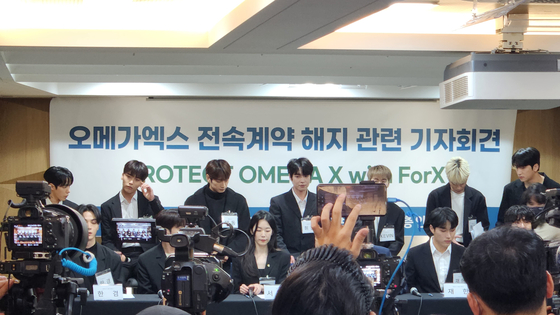 Members of Omega X speak during a press conference at the Seoul Bar Association's Human Rights Room in southern Seoul on Wednesday. [HALEY YANG]
