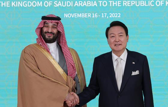 Korean President Yoon Suk-yeol, right and Saudi Arabian Crown Prince Mohammed bin Salman Al Saud shake hands before their bilateral summit at the presidential residence in Hannam-dong, Yongsan District, in central Seoul Thursday. [PRESIDENTIAL OFFICE]