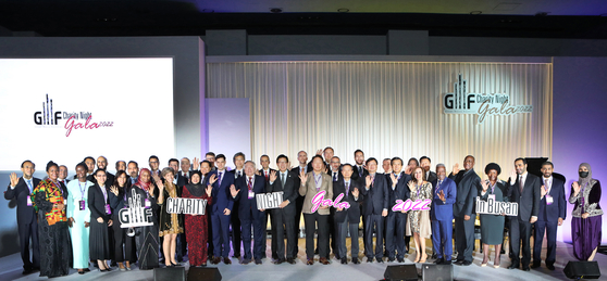 SK Group Chairman Chey Tae-won, eleventh from front right; Busan Mayor Park Heong-joon, twelfth from front right; Heart to Heart Foundation President and CEO Oh Jee-chul, tenth from front right; Korea JoongAng Daily CEO Cheong Chul-gun, ninth from front right; and members of the diplomatic corps in Korea representing some 40 countries celebrate the opening of the Great Music Festival Charity Night Gala 2022 in Busan at the Asti Hotel in Busan on Friday. [PARK SANG-MOON]