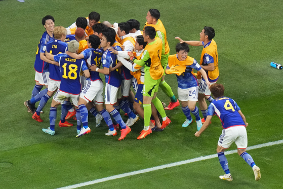 Japan celebrates after scoring during the World Cup group E soccer match between Germany and Japan, at the Khalifa International Stadium in Doha, Qatar on Wednesday. [AP/YONHAP]