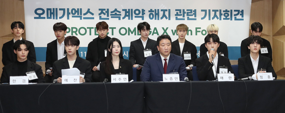 Members of Omega X speak during a press conference at the Seoul Bar Association's Human Rights Room in southern Seoul on Wednesday. [NEWS1]