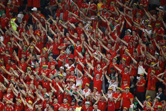 Wales fans cheer during a match against the USA at Ahmad bin Ali Stadium in Doha on Nov. 21. [EPA/YONHAP]