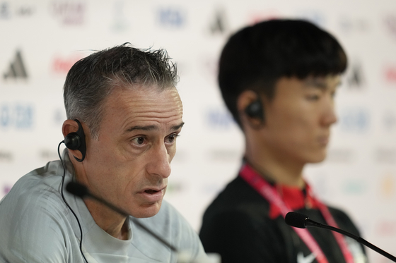 Korea's head coach Paulo Bento speaks alongside Hwang In-beom during a press conference at the Qatar National Convention Center on the eve of the Group H World Cup soccer match between Korea and Ghana in Doha, Qatar on Sunday. [AP/YONHAP]