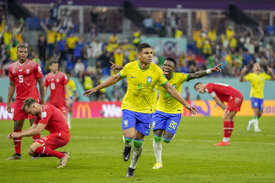 Brazil's Casemiro, center, celebrates after scoring his side's opening goal during the World Cup group G football match between Brazil and Switzerland, at the Stadium 974 in Doha, Qatar on Monday. [AP/YONHAP]